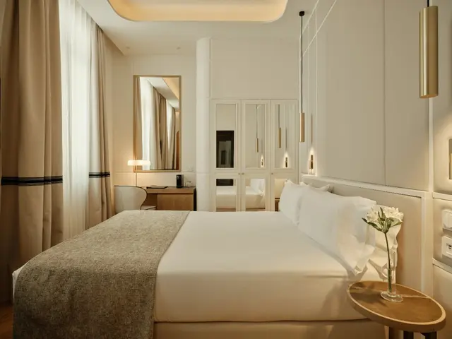 Deluxe Exterior Carmen room with bed, mirrored wardrobe and hanging brass lamps