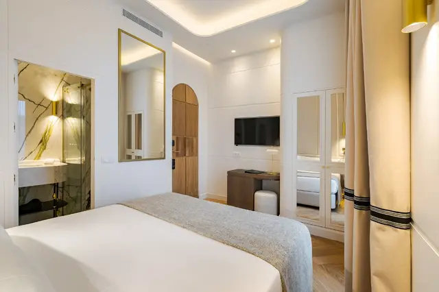 Full view of Deluxe Sol View room with TV area, desk and bathroom access