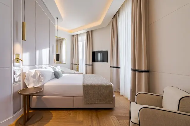 Premium Corner room with bed, armchair, Smart TV and large windows