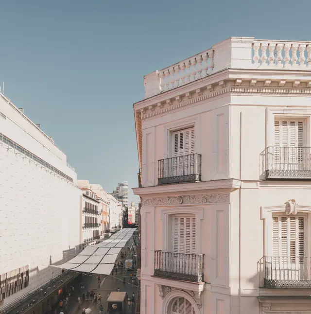 Vistas desde el balcón de la Premium Corner al edificio en esquina y a la calle Preciados con sus toldos