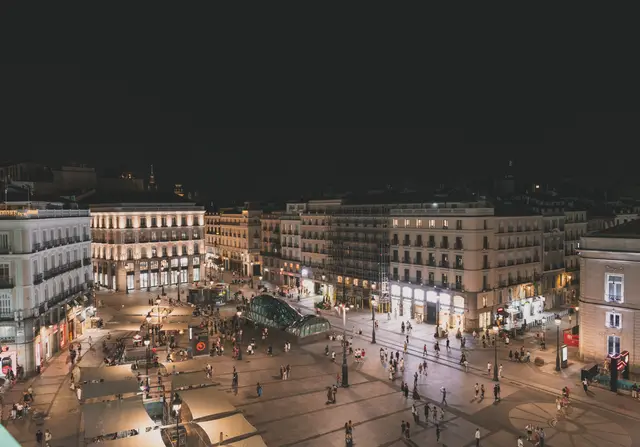 Panorámica nocturna de la Puerta del Sol con las calles y los edificios iluminados