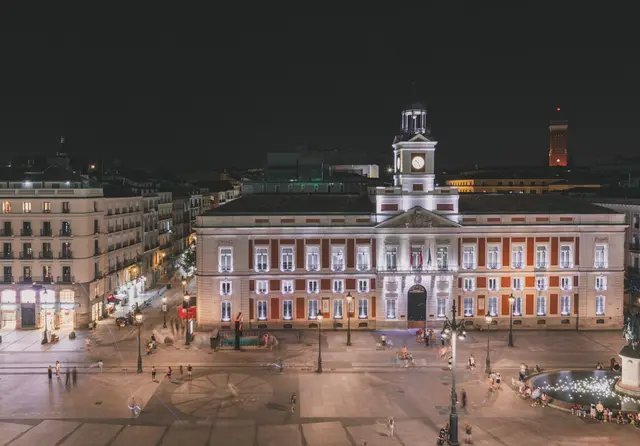 The Real Casa de Correos lit up at night above Puerta del Sol square